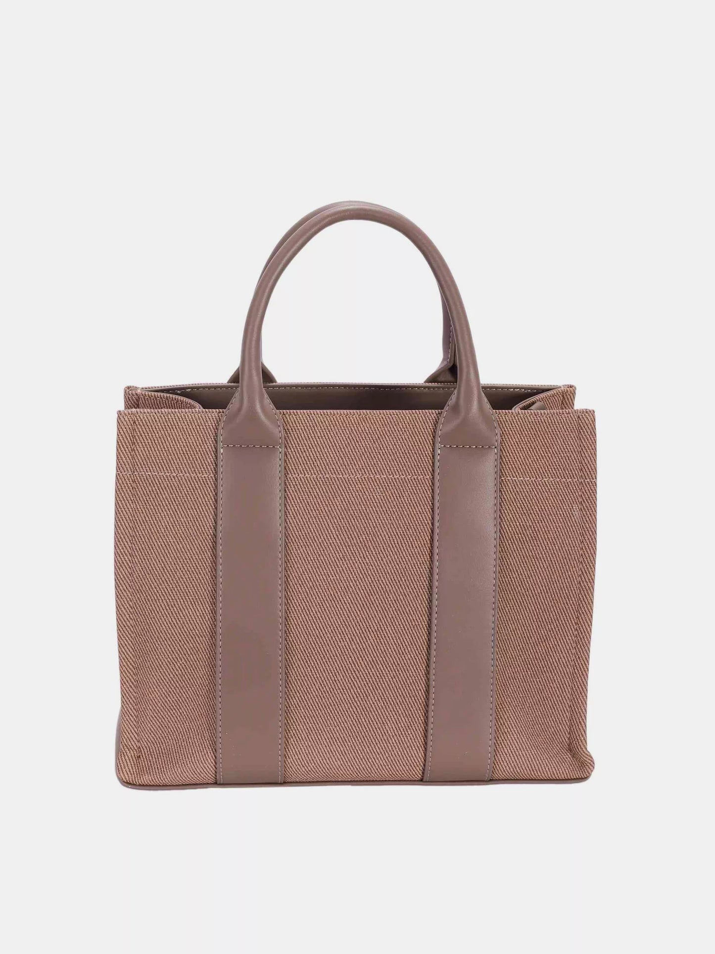 Brown tote bag with leather straps on a light gray background