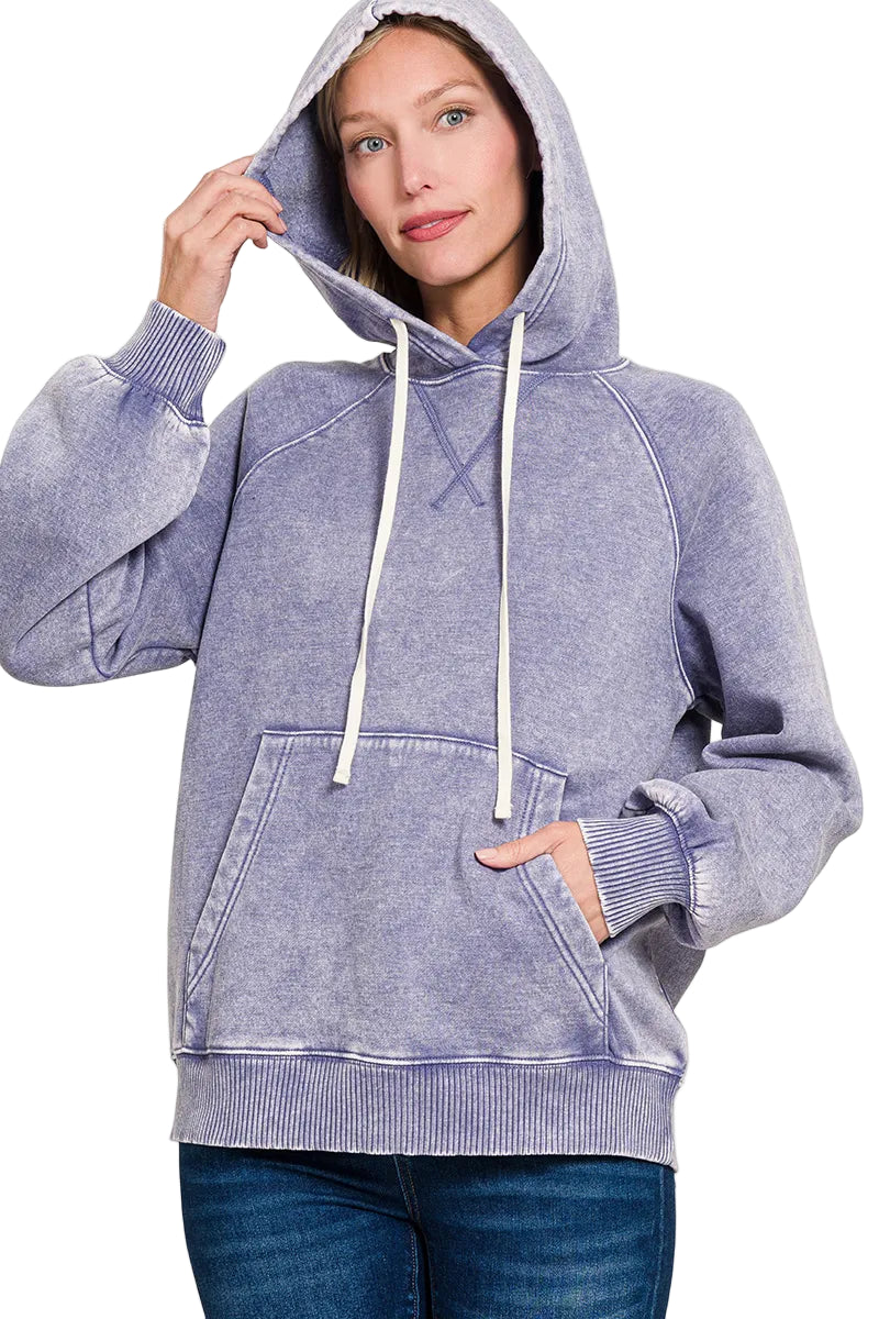 Woman wearing a marl blue hoodie with a white background