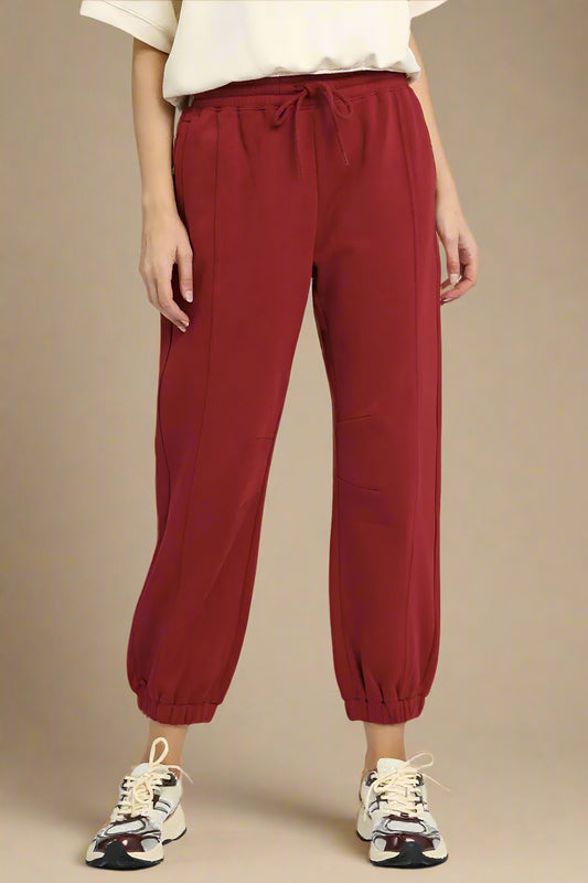 Red pants worn by a person on a plain background
