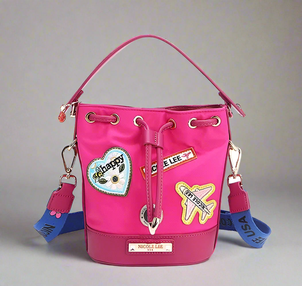 Pink bucket bag with patches and drawstring on a white background
