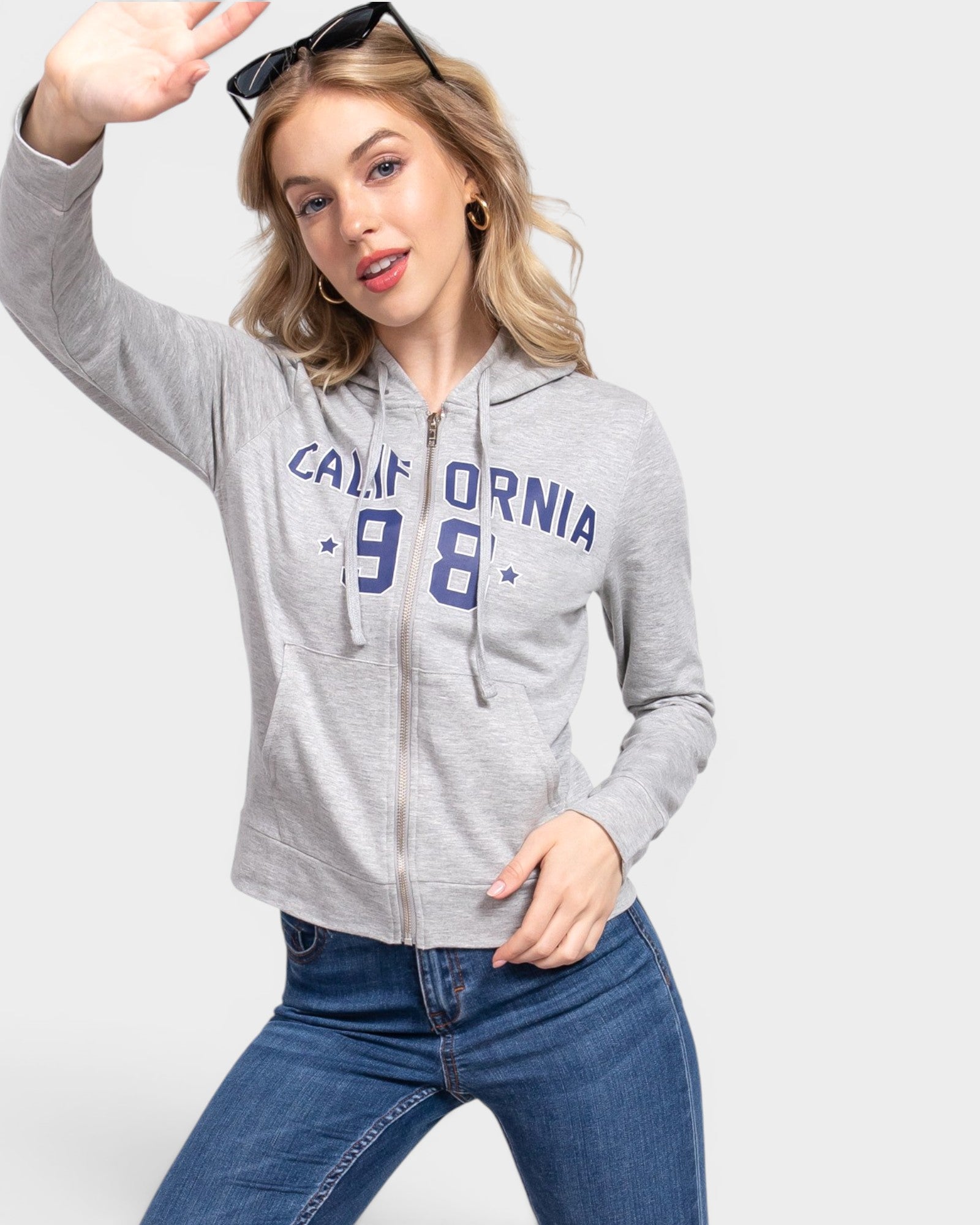 Woman wearing a gray hoodie with 'California 98' text on a white background