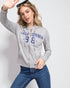 Woman wearing a gray hoodie with 'California 98' text on a white background