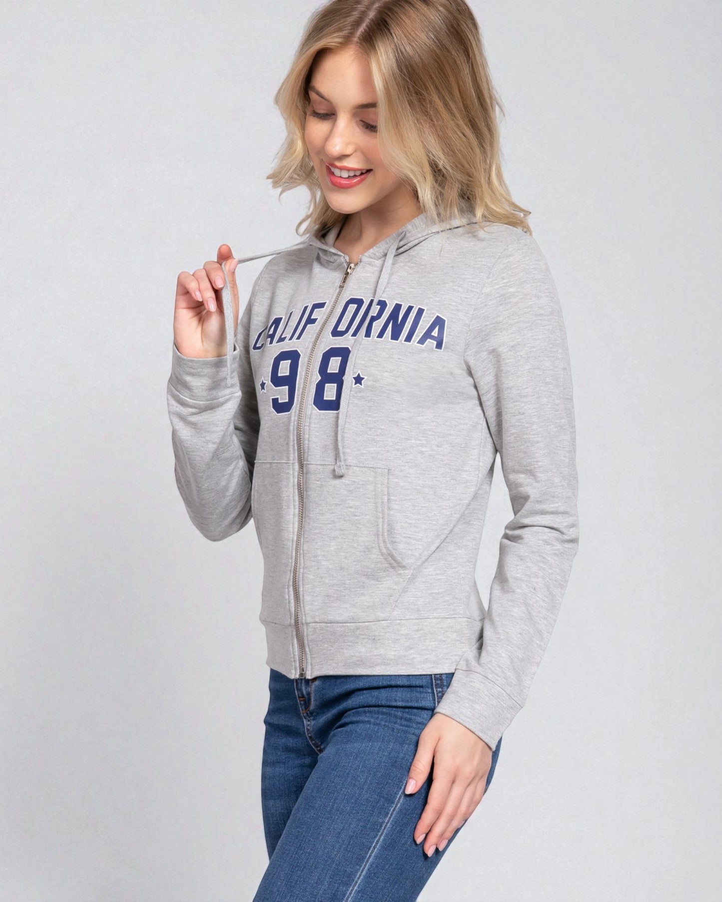 Woman wearing a gray hoodie with 'California 98' text on a light gray background