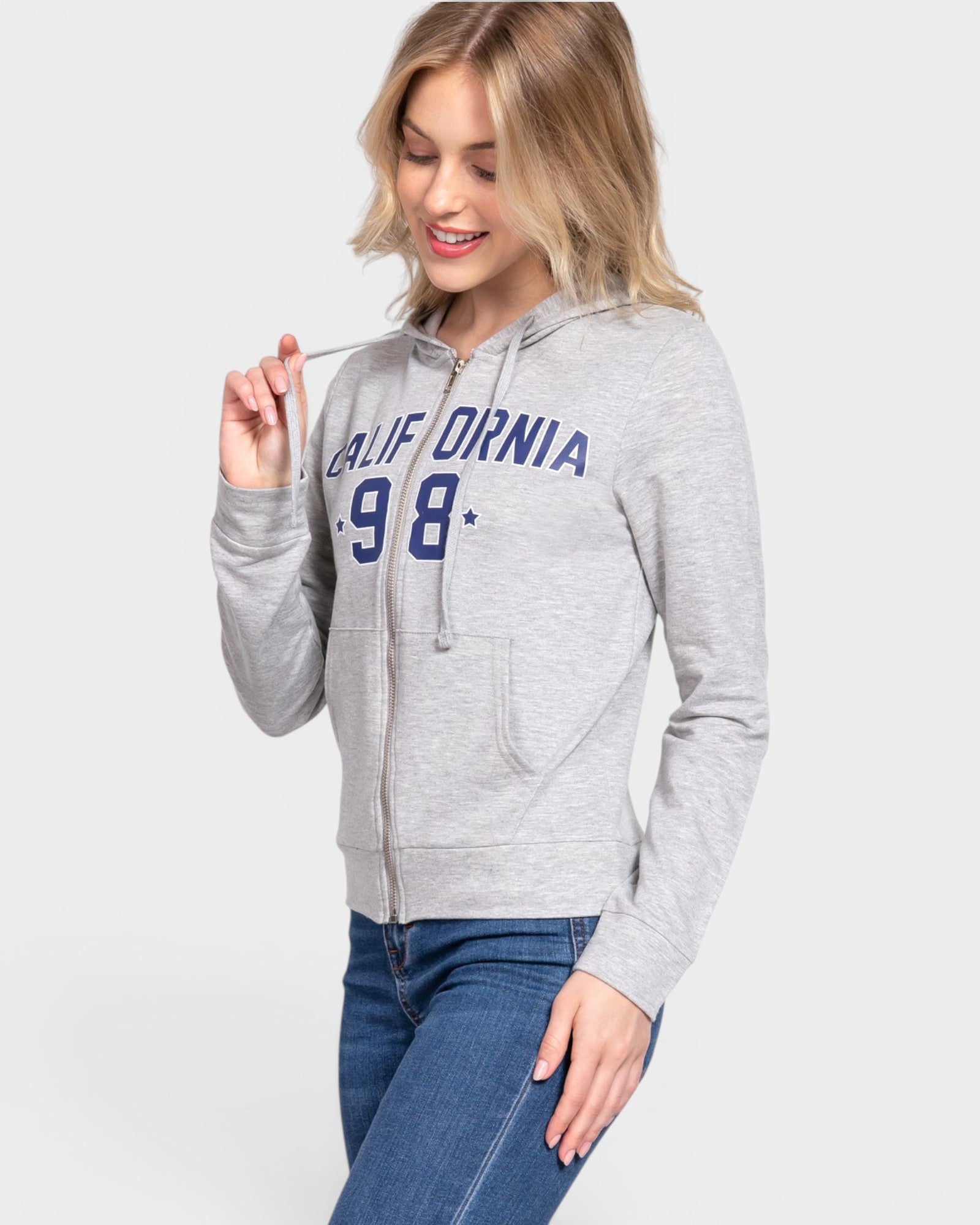 Woman wearing a gray hoodie with 'California 98' text on a light gray background