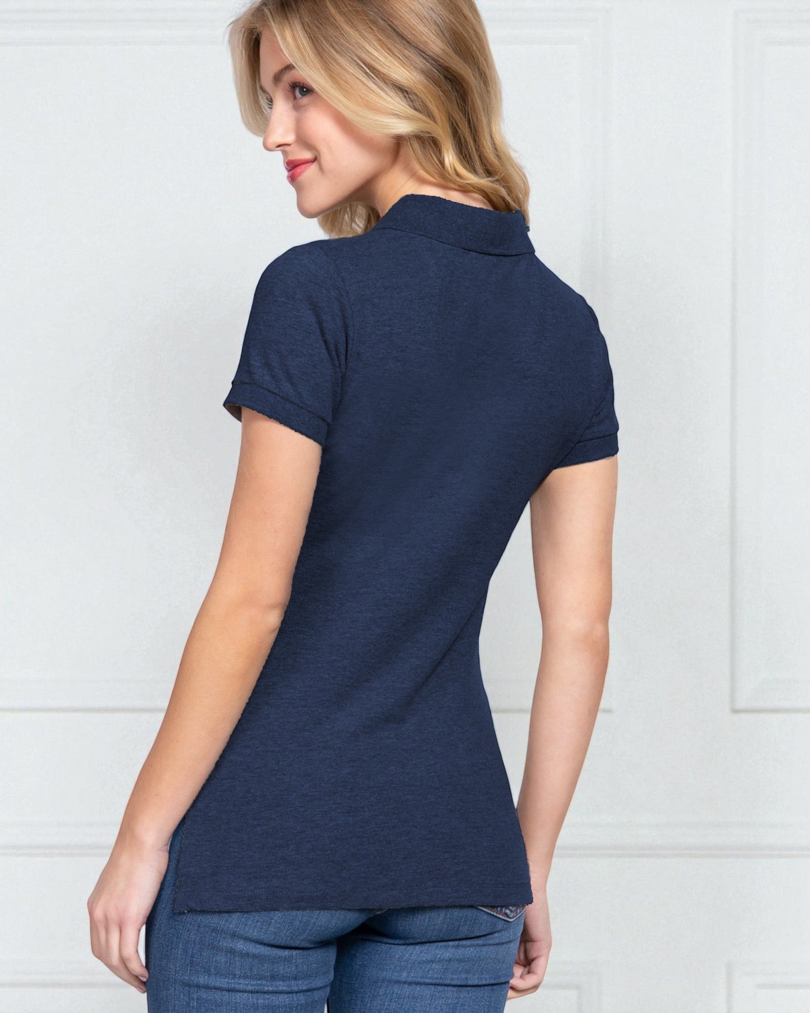 Woman wearing a navy blue polo shirt against a white background