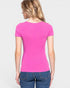 Woman wearing a pink t-shirt and blue jeans on a plain background
