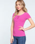 Woman wearing a pink lace-up top and blue jeans on a white background