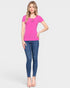 Woman wearing a pink top and blue jeans on a white background