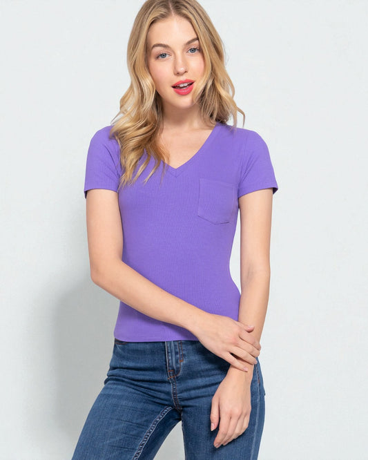 Woman wearing a purple t-shirt and blue jeans on a light gray background