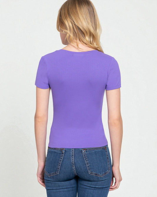 Person wearing a purple t-shirt and blue jeans on a light gray background