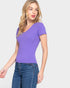 Woman wearing a purple top and blue jeans on a white background