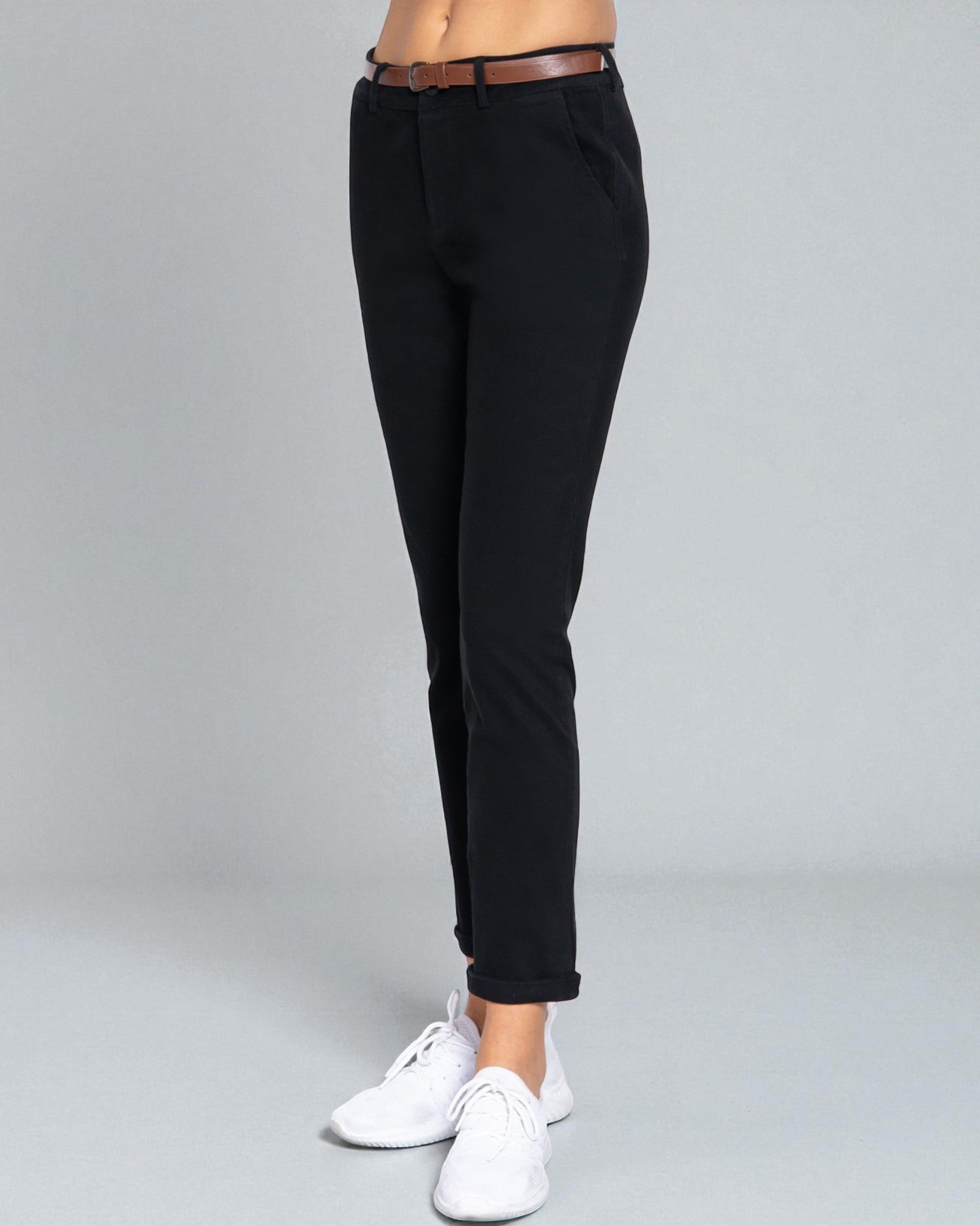 Black pants worn by a person on a gray background