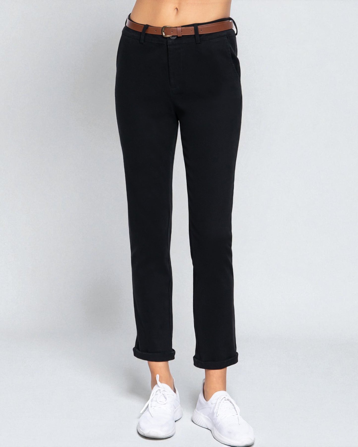 Black jeans worn by a person on a white background