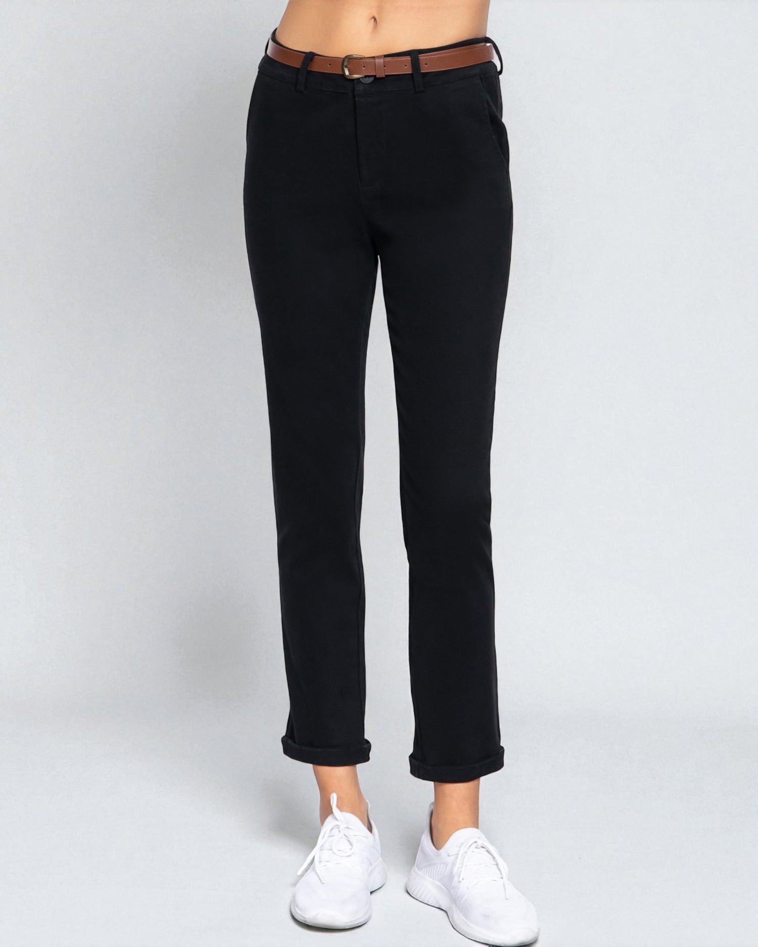 Black jeans worn by a person on a white background