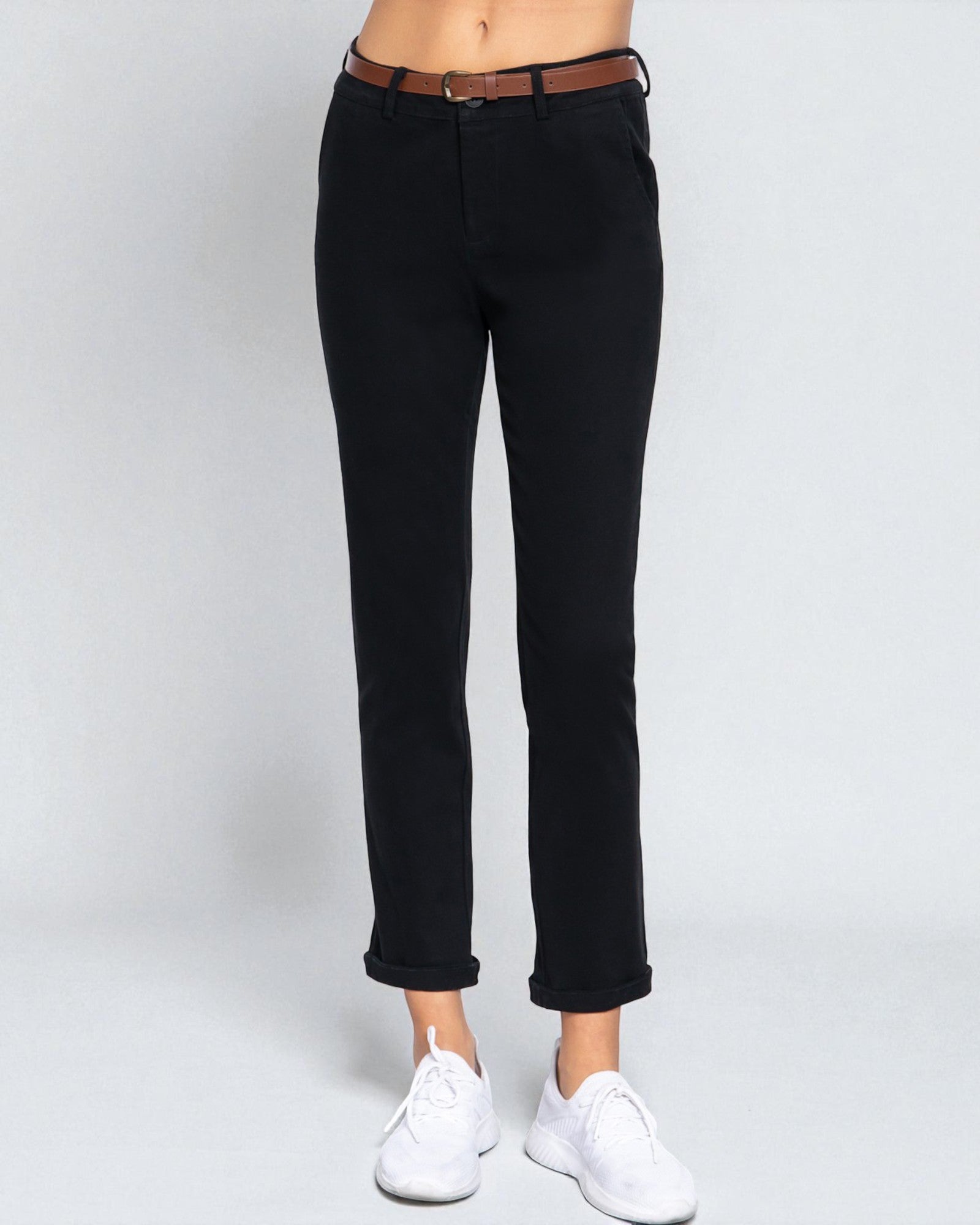 Black jeans worn by a person on a white background