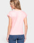 Woman wearing a pink t-shirt and blue jeans on a white background