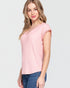 Woman wearing a pink top and blue jeans on a light gray background