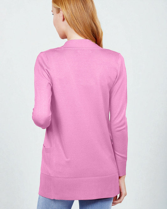 Pink sweater worn by a person on a light gray background