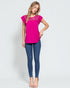 Woman wearing a pink top and blue jeans on a white background