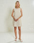 Woman wearing a white lace dress against a white background