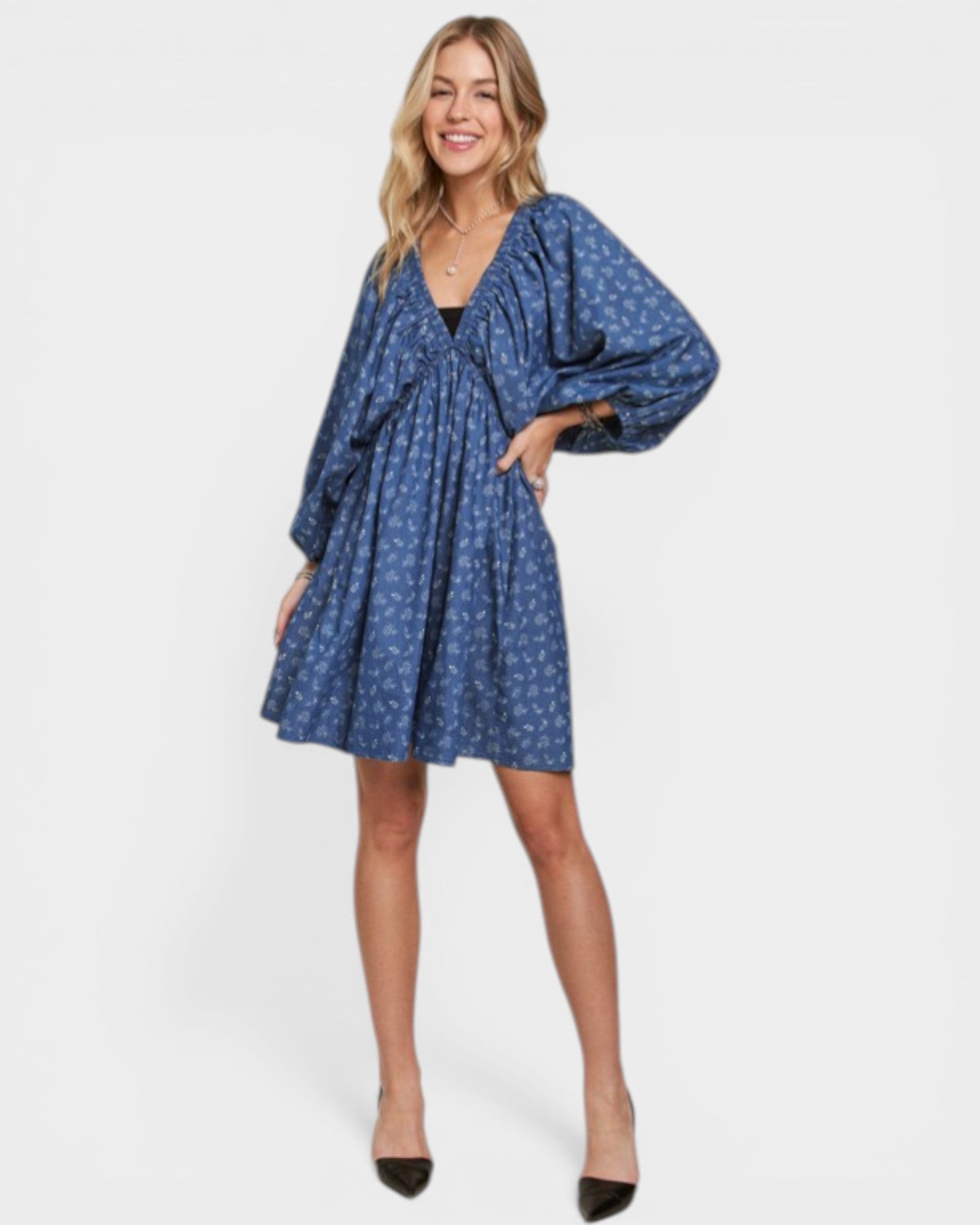 Woman wearing a blue patterned dress on a white background