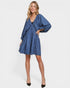 Woman wearing a blue patterned dress on a white background