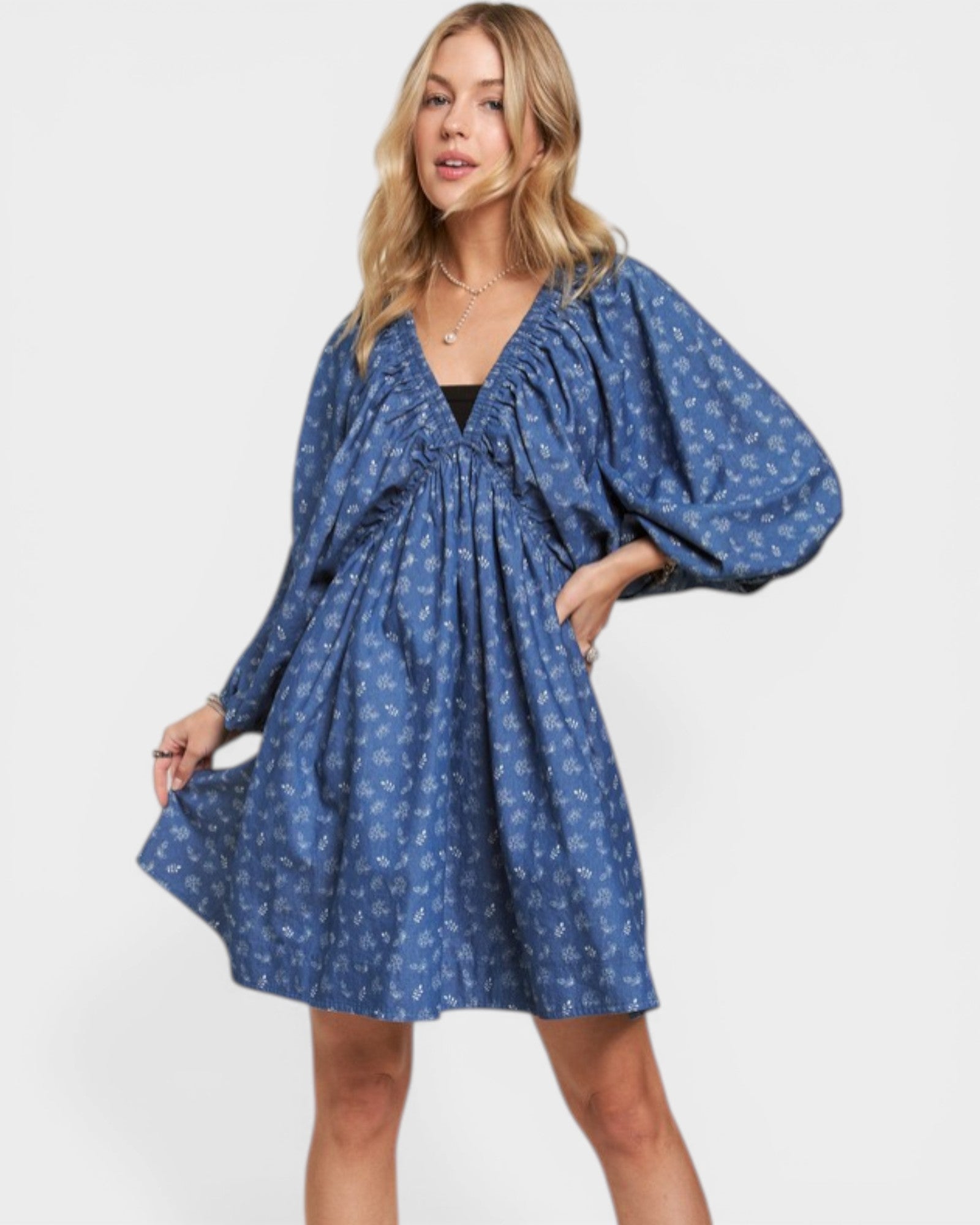 Woman wearing a blue patterned dress on a white background