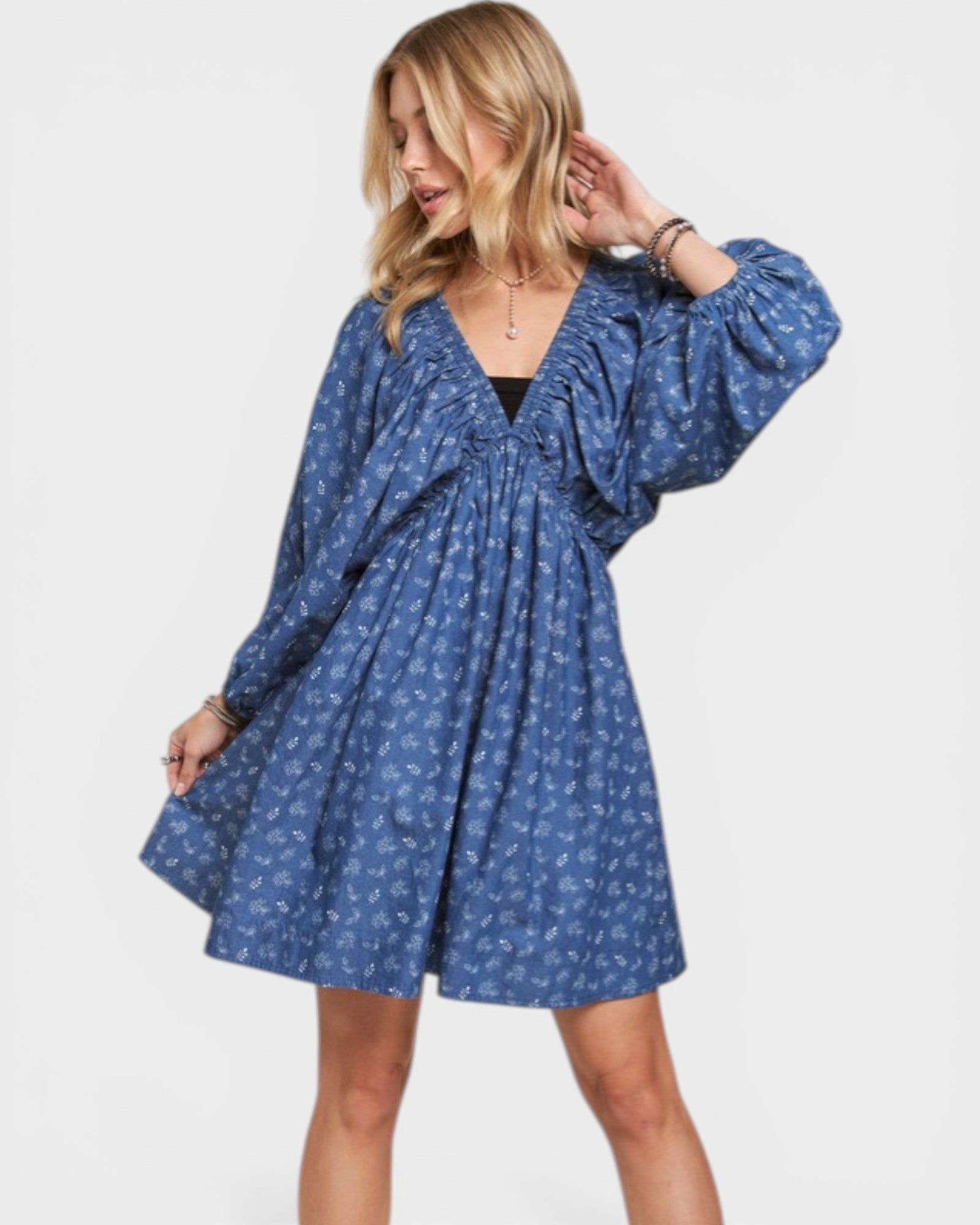 Woman wearing a blue patterned dress on a white background