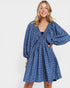 Woman wearing a blue floral dress on a white background