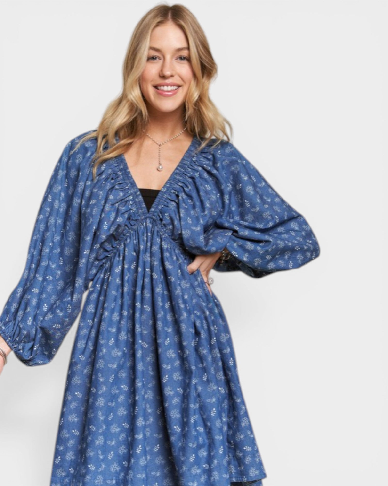 Woman wearing a blue patterned dress on a white background