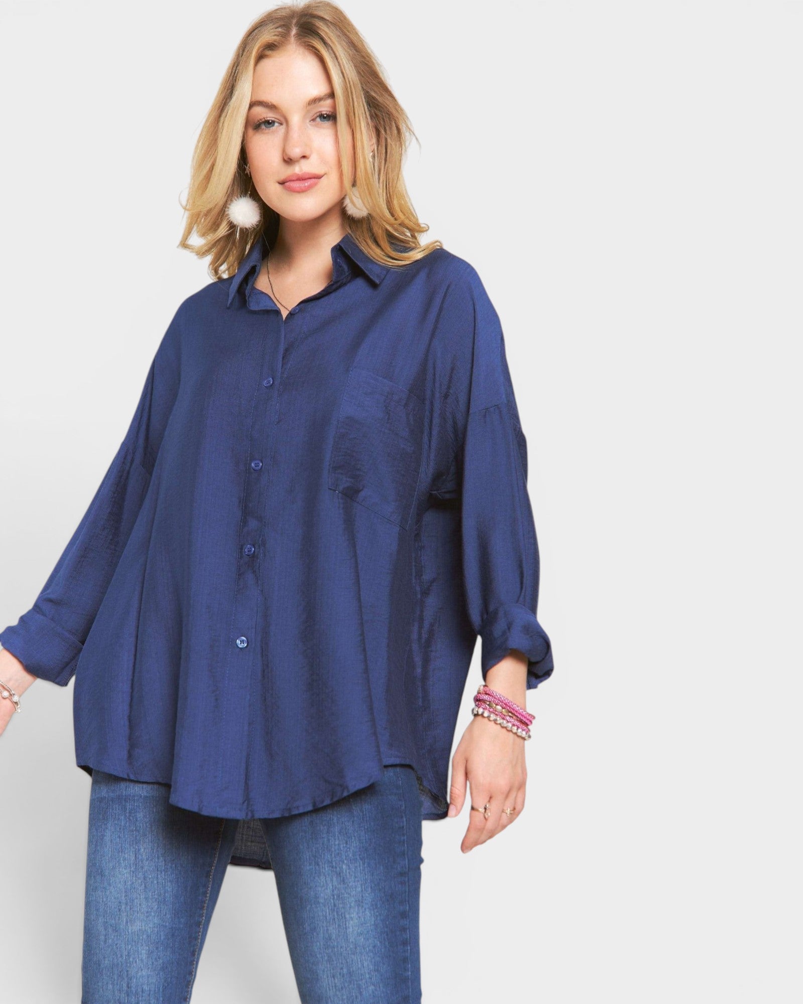 Woman wearing a blue shirt and jeans on a white background