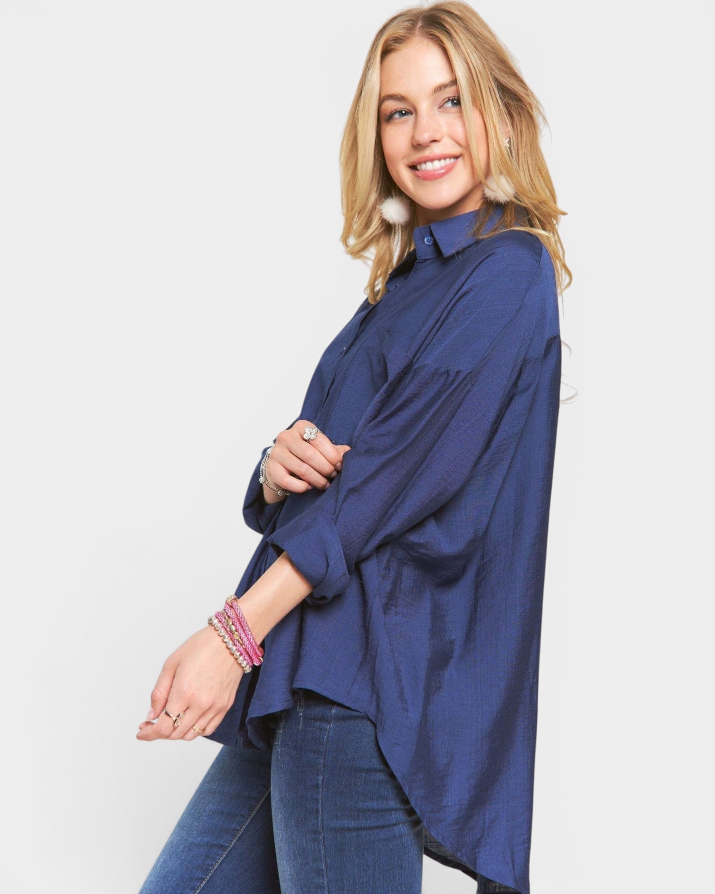 Woman wearing a blue oversized shirt on a white background