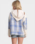 Person wearing a blue plaid shirt with a white hood over it on a plain background