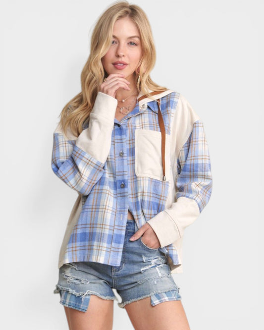 Woman wearing a blue and white plaid shirt with a hood on a white background