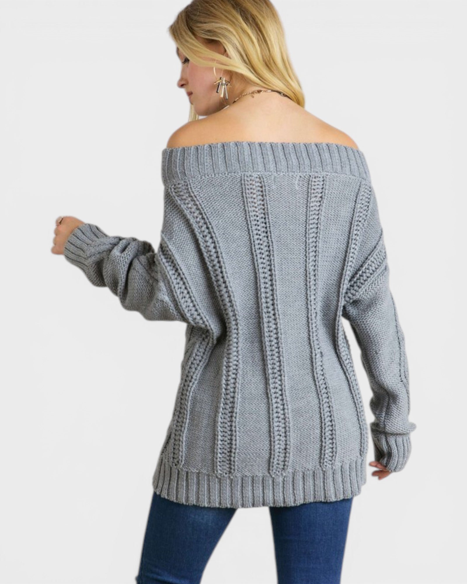 Woman wearing a gray off-shoulder sweater on a white background