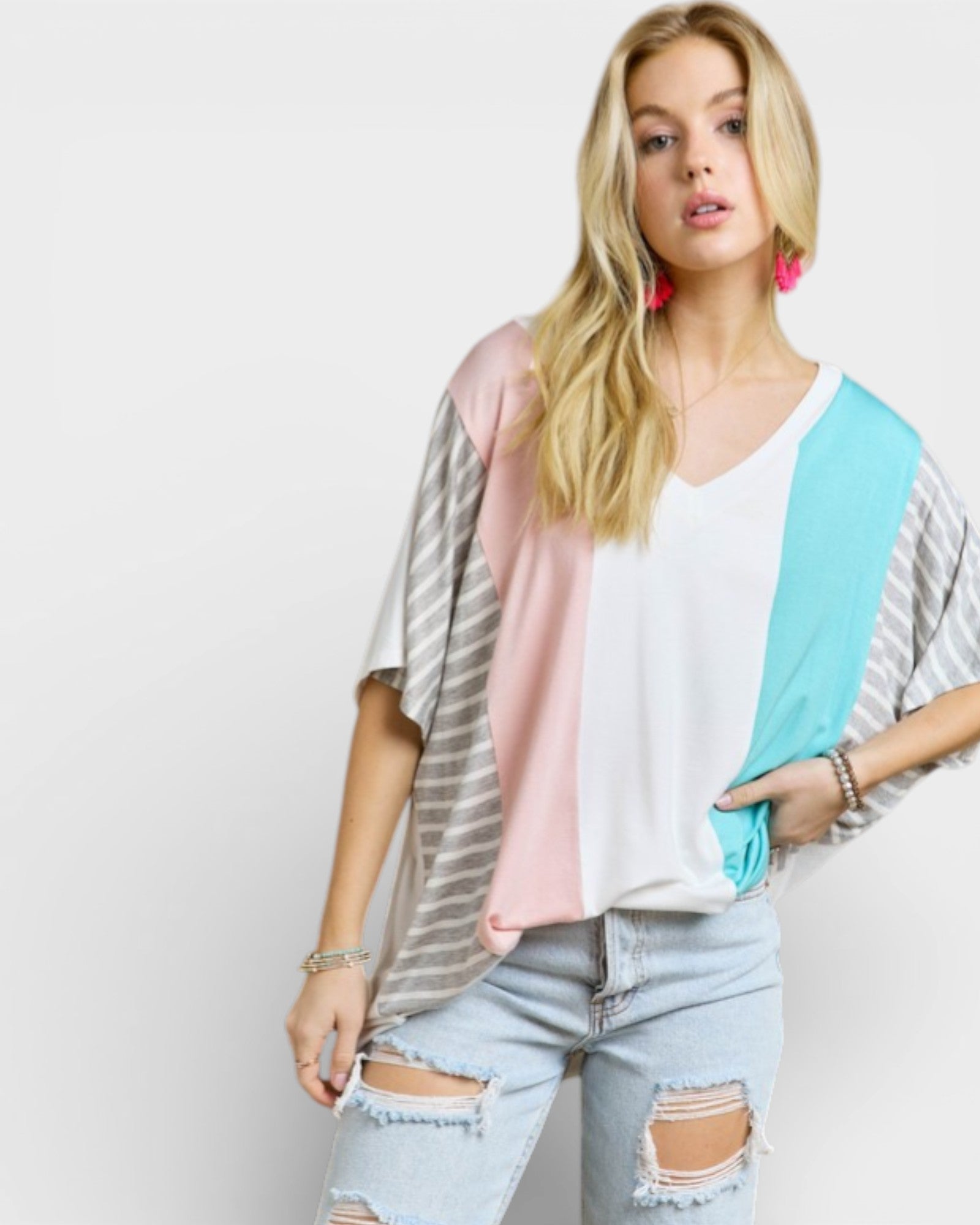 Woman wearing a colorful top with a plain background