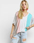 Woman wearing a colorful top with a plain background