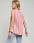 Woman wearing a pink striped sleeveless top and light blue jeans on a plain background