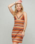 Woman wearing a patterned dress against a plain background