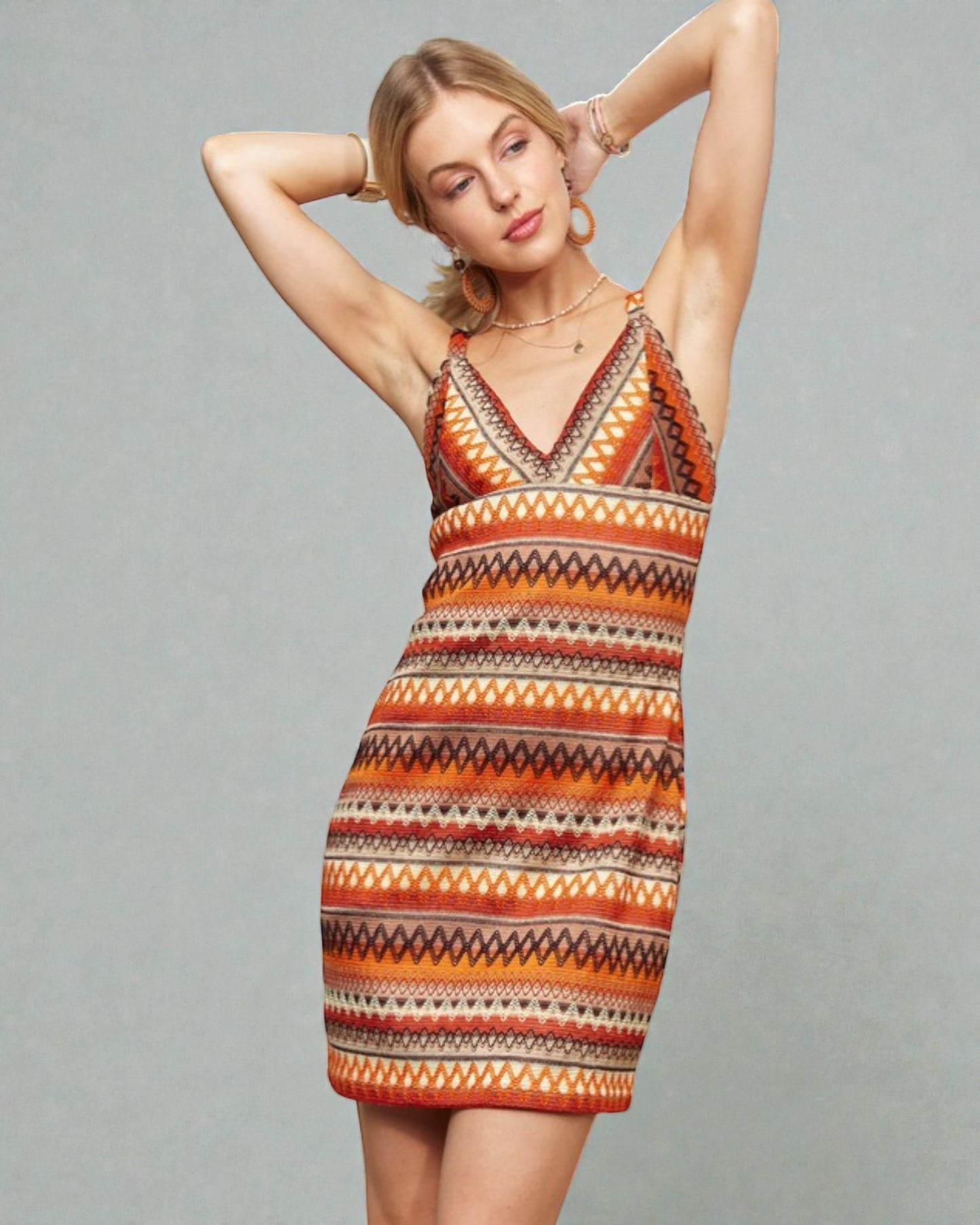 Woman wearing a patterned dress against a gray background