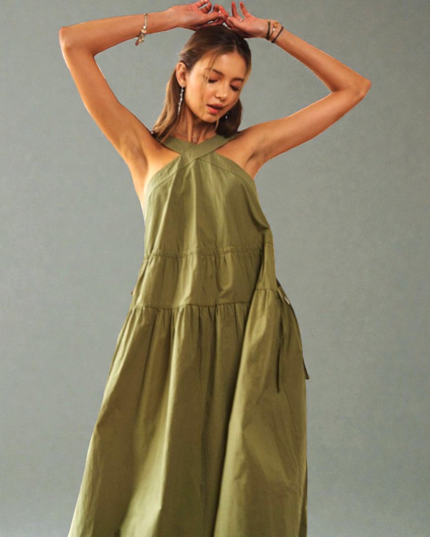 Woman wearing a green dress against a gray background
