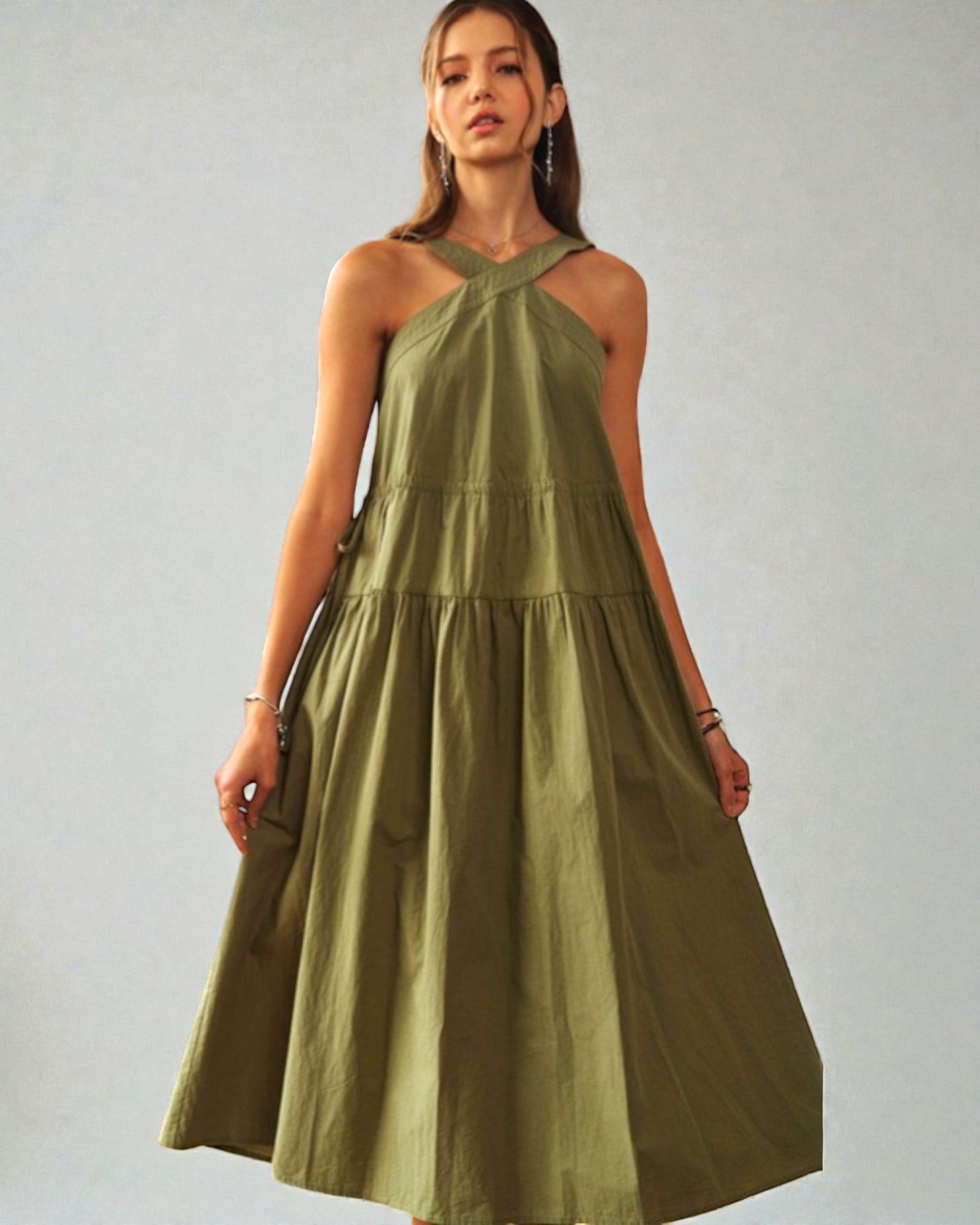 Woman wearing a green dress against a plain background