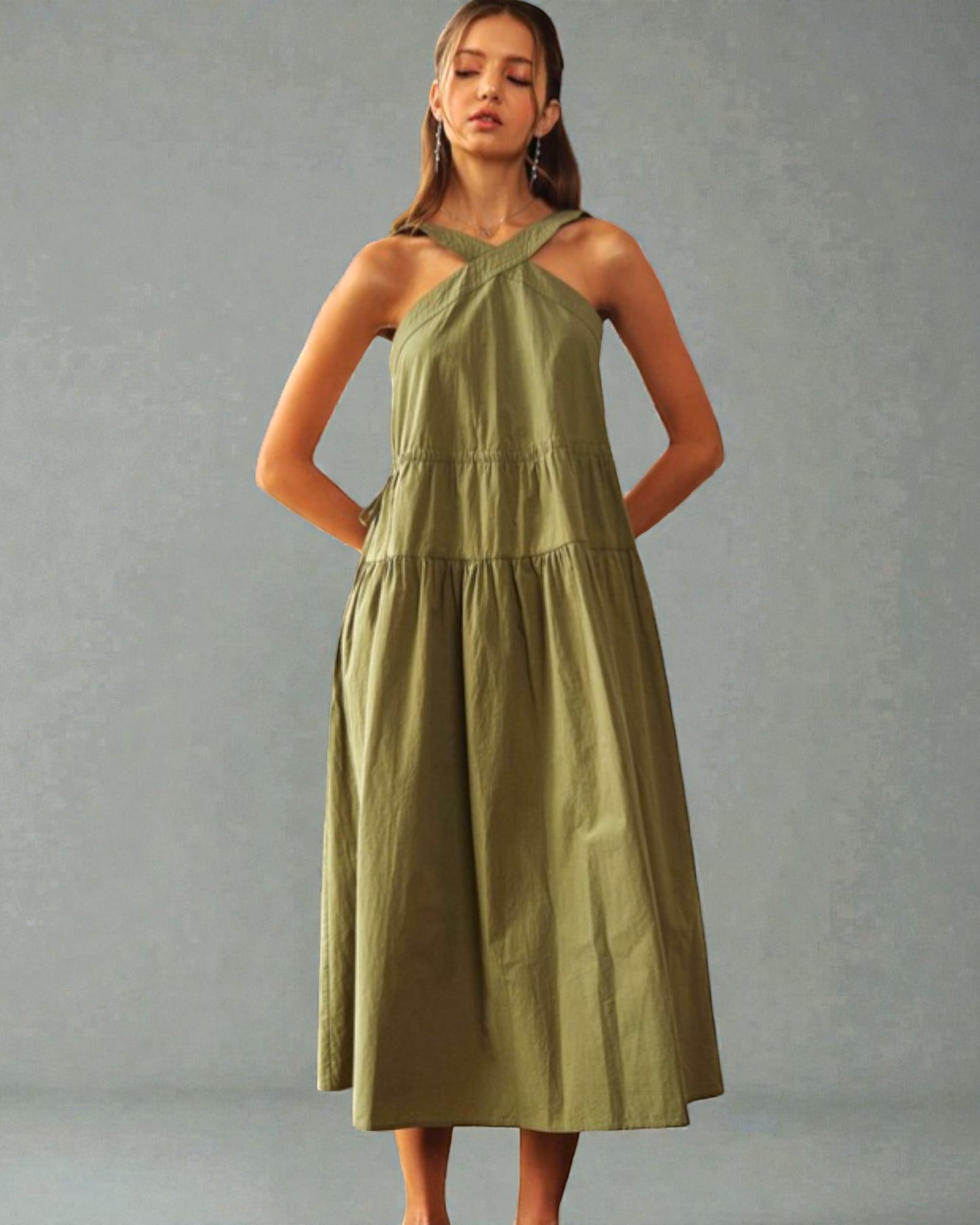 Woman wearing a green dress against a gray background