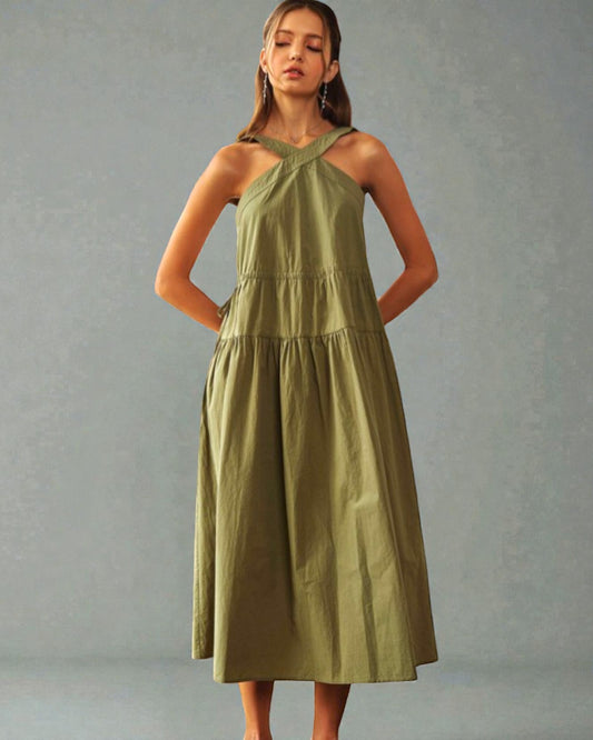 Woman wearing a green dress against a gray background