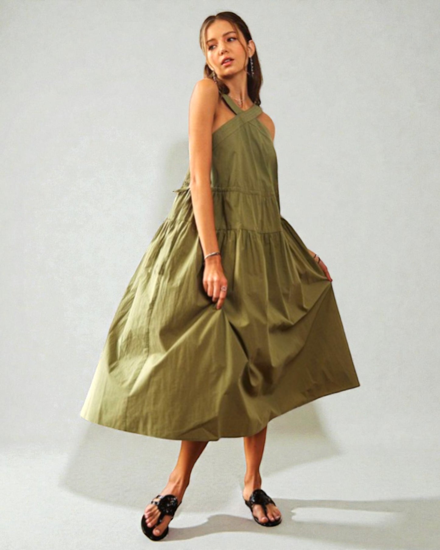 Woman wearing a green dress against a white background
