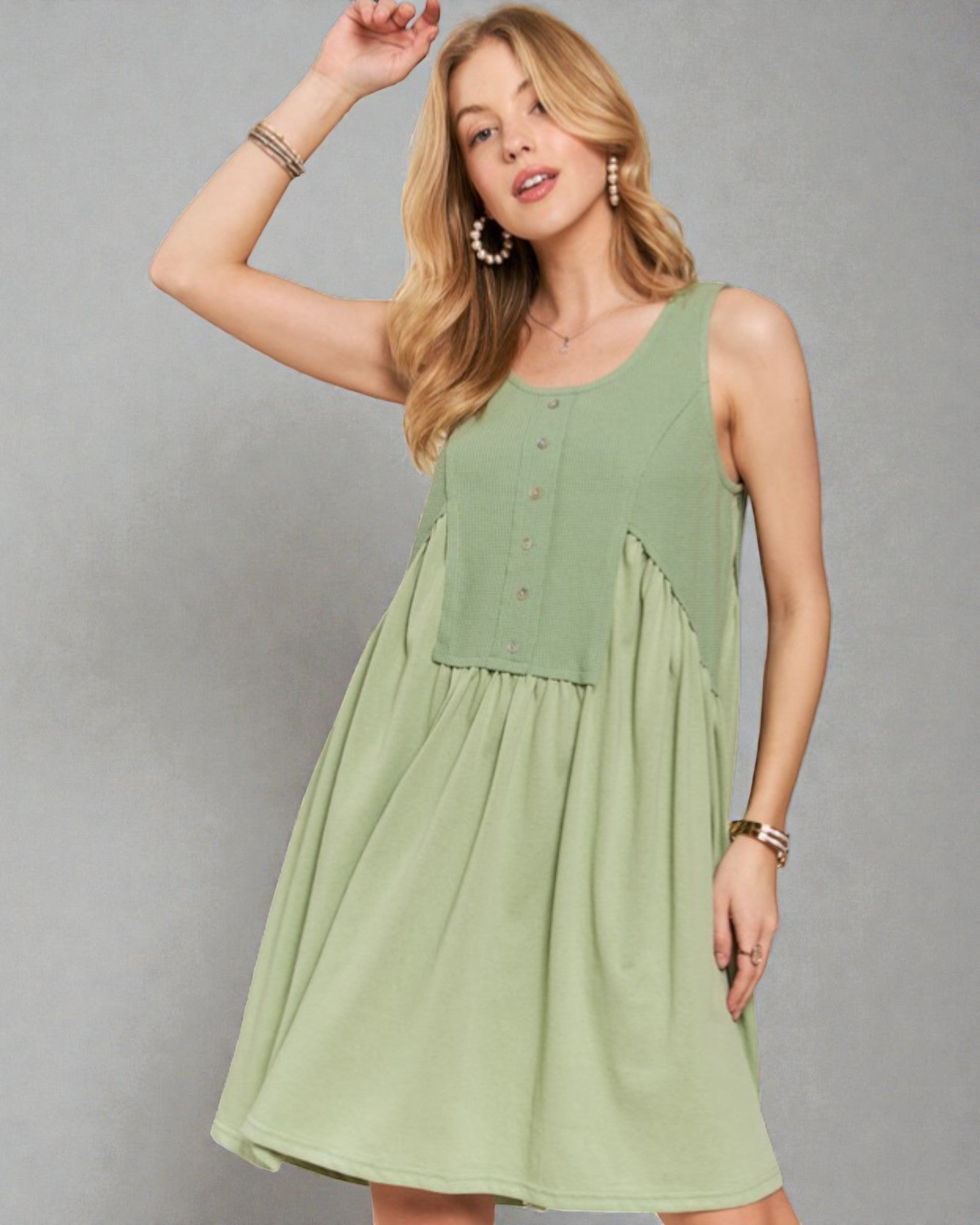 Woman wearing a green dress against a gray background