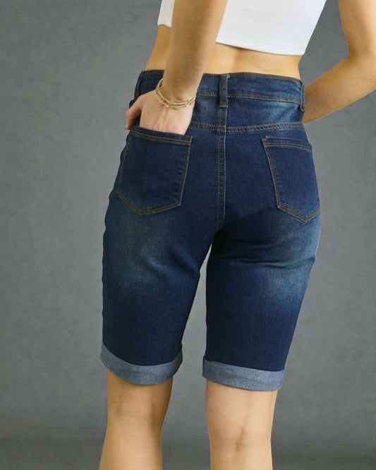 Person wearing blue denim shorts on a gray background