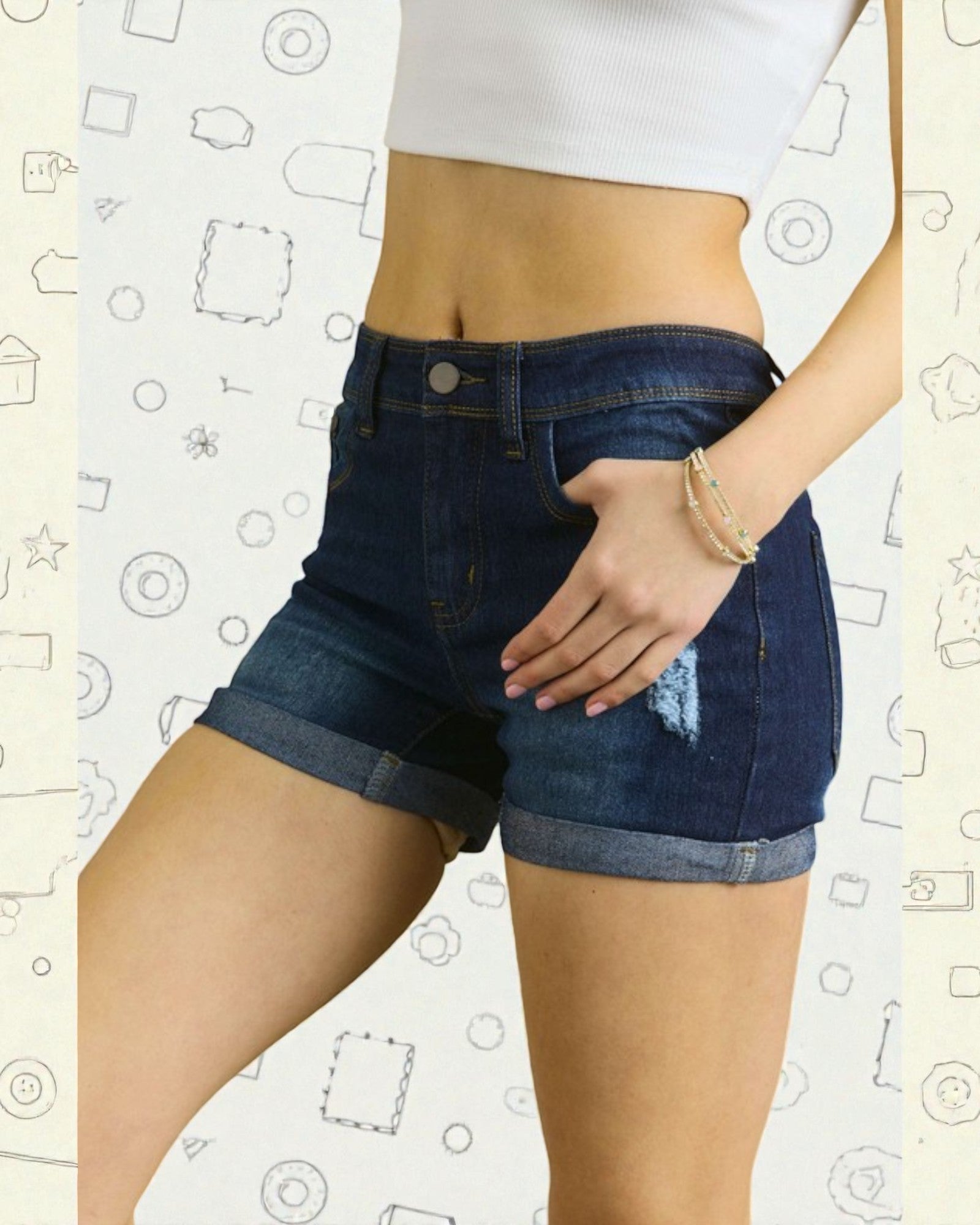 Person wearing blue denim shorts with a white background