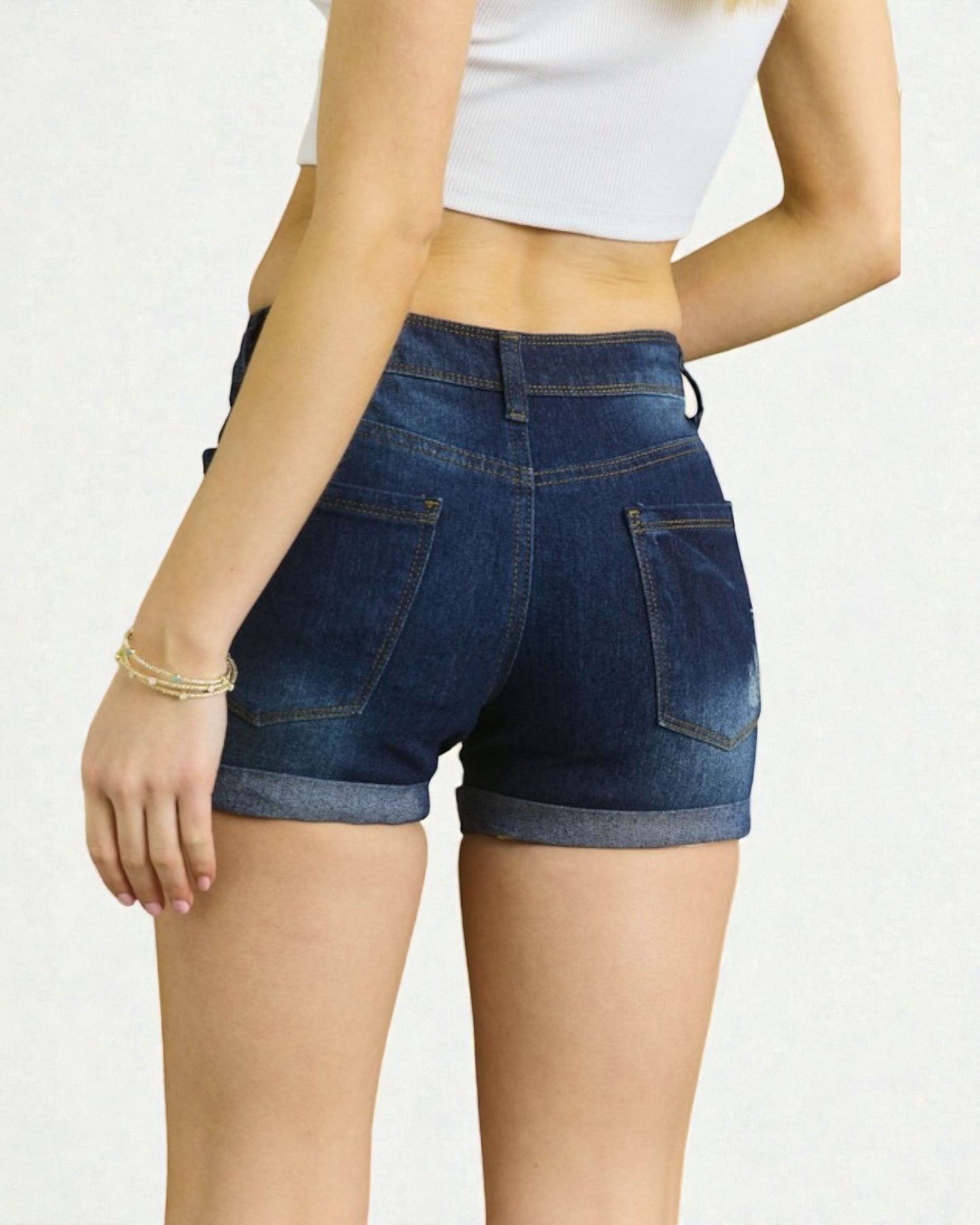 Person wearing blue denim shorts on a white background