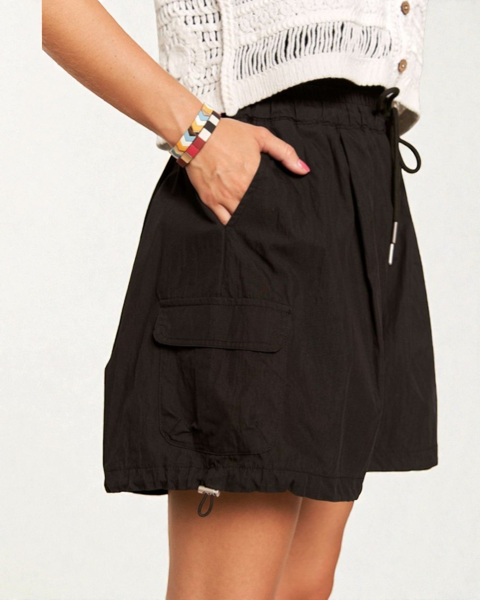 Black skirt worn by a person on a white background